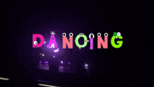 the word dancing is displayed on a dark background