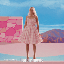 a poster for the barbie movie shows a woman in a pink dress dancing on a bed