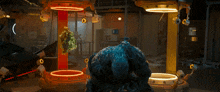 a blue monster is standing in front of a yellow and red display