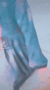 a woman in a blue dress is holding a man 's hand
