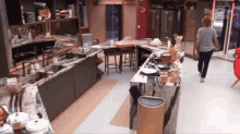 a woman walking through a kitchen with the word big on the corner