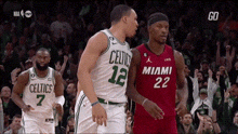 two basketball players from the celtics and the miami heat are talking to each other