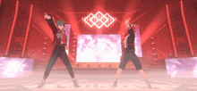 a couple of people are dancing on a stage with skulls on it