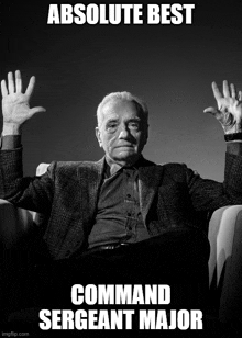 a man in a suit is sitting in a chair with his hands in the air and the caption absolute best command sergeant major