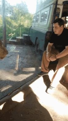 a man is looking at a lion through a glass window