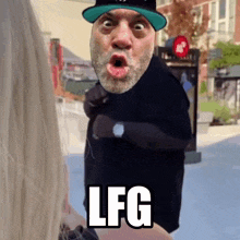 a man with a beard and a hat says lfg on his face