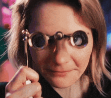 a close up of a woman wearing a pair of glasses