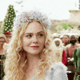 a woman with blonde hair wearing a crown of flowers