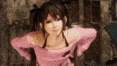 a girl with pigtails and a pink sweater is standing in front of a brick wall