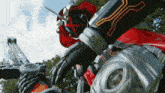 a robot with a red cape is holding a sword in his hand