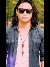 a man with long hair wearing sunglasses and a necklace