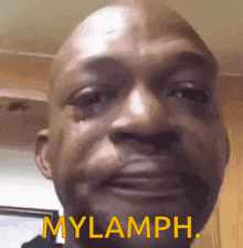 a close up of a man 's face with the words mylamph written in yellow