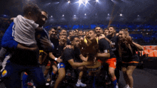 a group of people holding a trophy that says ' champions league '