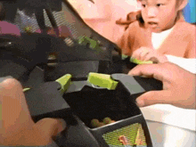 a child is playing with a toy that looks like a ninja turtle
