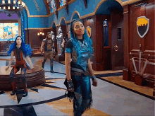 a woman with blue hair is standing in a hallway with a sword and shield
