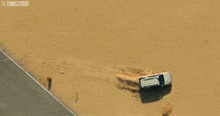 a man wearing sunglasses is driving a c4d3g