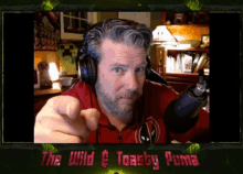 a man wearing headphones pointing at the camera with the words the wild & toasty puma below him