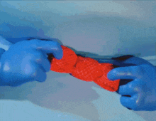 a blue frog with a red bow tie is standing on a pink background