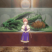 a girl in a blue dress is standing in front of a large fish tank