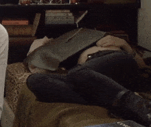 a person laying on a bed with a book on their lap that says ' courage ' on it