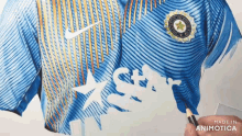 a person is drawing a blue shirt with the words made in animotica on the bottom right