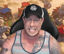 a man wearing a hat and a tank top with a dragon tattoo on his chest