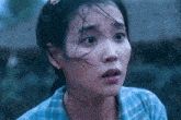 a close up of a woman 's face with a surprised expression