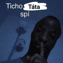 a man is making a shhh gesture with his finger on his lips .