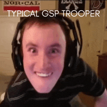 a man wearing headphones is smiling with the words typical gsp trooper behind him