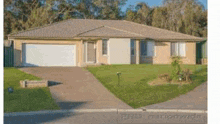 a house with a white garage door and a lush green yard