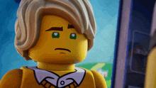 a close up of a lego figure with a sad face