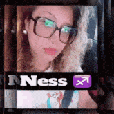 a woman wearing glasses with the word ness on the bottom right