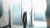 a blurry picture of people walking in a hallway with the word idna on the bottom left