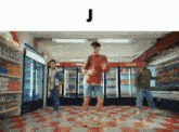 a man in a red shirt is dancing in a store with the letter j below him