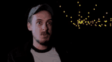 a man with a beard is standing in front of a screen that says " moving on "