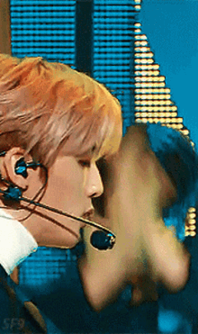 a close up of a person wearing a microphone and earphones