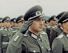 a man in a military uniform salutes in a line