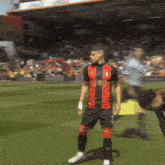 a soccer player in a red and black jersey with the number 18 on it