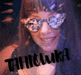 a woman wearing a veil and sunglasses with the word tahhowka written on the bottom