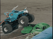 a monster truck that looks like a fish is jumping in the air