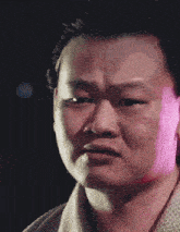 a close up of a man 's face with chinese characters on it