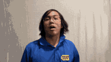 a man wearing a blue shirt that says best buy