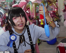 a girl wearing a pin that says ' happy birthday boy ' on it