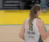 a female basketball player wearing number 18 rebel soder jersey