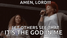a woman is singing into a microphone while another woman looks on and says amen , lord !