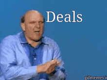 a man in a blue shirt stands in front of a blue background that says deals deals
