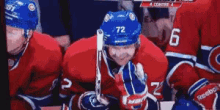 a hockey player with the number 72 on their helmet