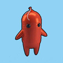 a red inflatable cartoon character with blue eyes is floating in the air