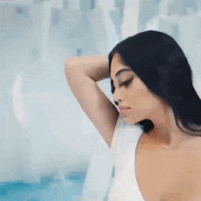 a woman with long black hair is wearing a white shirt with a plunging neckline