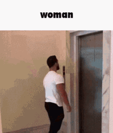 a man in a white shirt is standing in front of an elevator with the word woman below him .